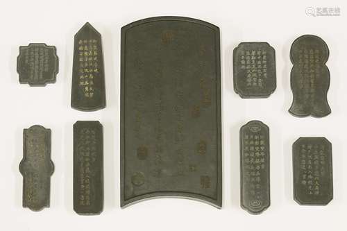 A collection of Chinese ink stones, one in the form of a screen panel, moulded with scholars in a ...