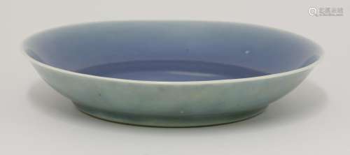 A dish, 18th century, covered in an uneven bubbled blue glaze, the exterior yellowy-green, a brown ...