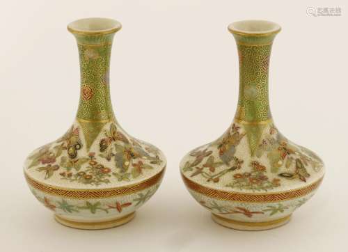 A pair of Tokyo 'Satsuma' vases, late 19th century, of depressed onion body with long neck and ...