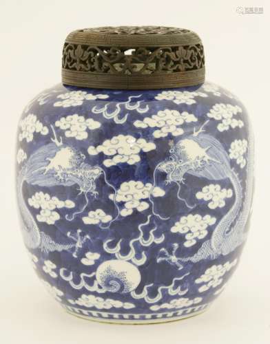 A Chinese blue and white ginger jar, c.1900, painted with dragons chasing a flaming pearl amongst ...