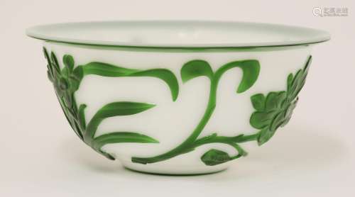 A Chinese overlay Peking glass bowl, decorated in emerald green against a white ground with orchid, ...