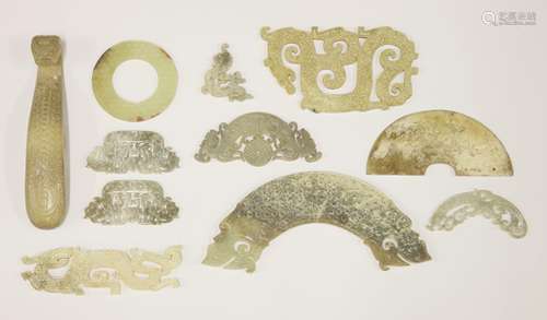 A collection of eleven Chinese jade carvings, modern, in archaic style, carved with belt hook and ...