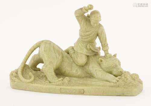 A Chinese soapstone carving, 20th century, with Wu Song beating a tiger, the stone in an even pale ...