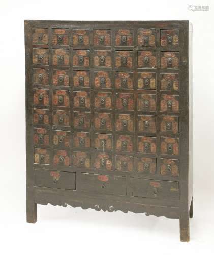 A Chinese lacquered medicine chest, early 19th century, of elm wood, with fifty-six herb drawers ...