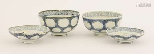 A pair of Japanese Arita blue and white bowls and covers, 18th century, painted with spiky roundels ...