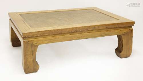 A Chinese elm kang table, early 20th century, with a cane top on four horse hoof legs, 128cm wide ...