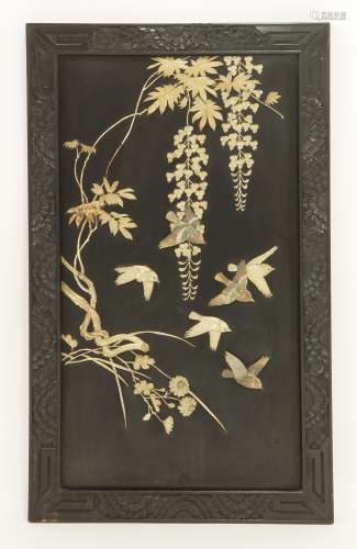 A Japanese black lacquered panel,  c.1880, onlaid with birds flying amongst blossoming wisteria in ...