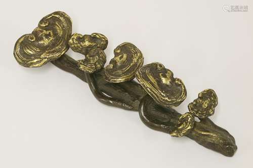 A Chinese bronze scroll weight, 17th century or later, in the shape of a branch of lingzhi, gilded, ...