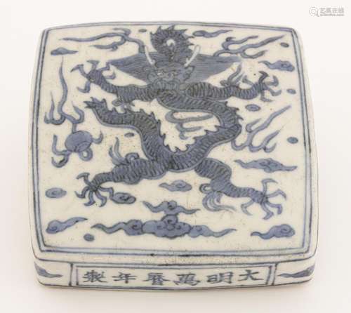 A blue and white scroll weight, of square form, painted with a dragon chasing a flaming pearl ...