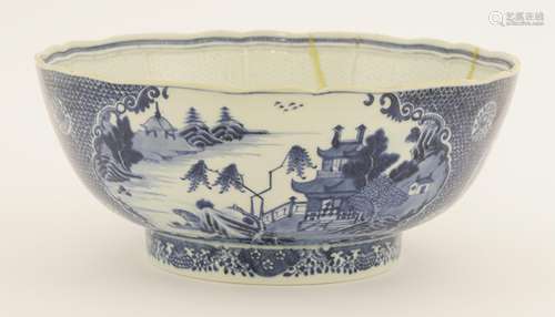 A Chinese blue and white punch bowl, late 18th century, the lobed circular form painted with watery ...