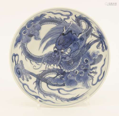 A Chinese blue and white dish, Yongzheng (1723-1735), painted with a dragon grasping a flaming ...
