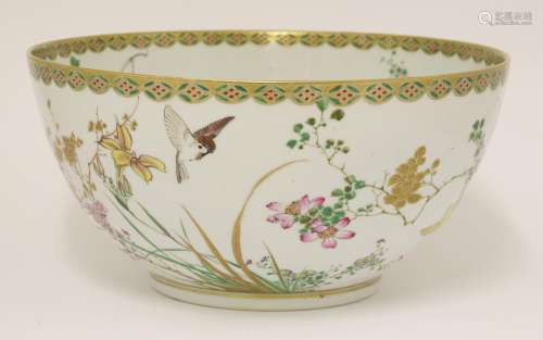 A Japanese punch bowl, c.1900, painted with birds amongst sprigs of blossoming flowers, below a ...