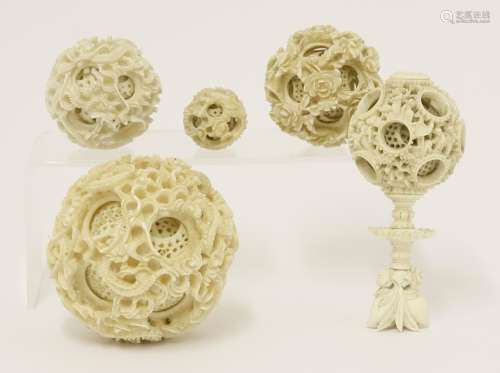 Five Canton ivory balls, late 19th century, three exteriors carved with dragons amongst clouds, one ...