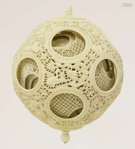 A large Canton ivory ball,  late 19th century, the exterior carved and pierced with dragons amongst ...