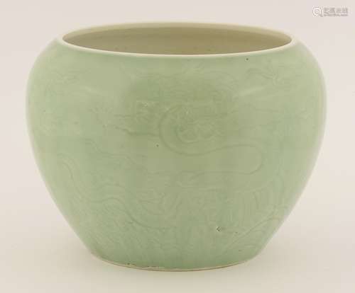 A celadon cachepot, modern, incised with dragons above spuming waves, 26cm diameter