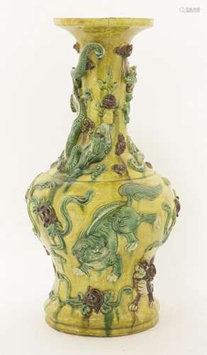 A Chinese sancai vase, 20th century, of baluster form moulded with Buddhist lions, surrounded by ...