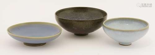 Three Chinese bowls, in the style of jun ware, each under a blue or an aubergine glaze, 13.7 to ...