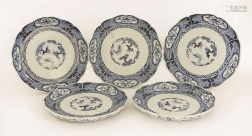 A set of five Japanese plates,  18th century, of floral shape, the centre painted with the Three ...
