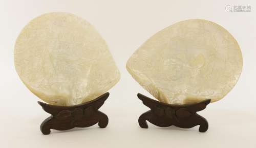 Two Chinese Canton carved clamshells, 19th century, both well detailed with a complex battle scene ...