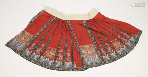 A Chinese skirt, late Qing dynasty, the main panel embroidered with a dragon amongst Buddhist ...