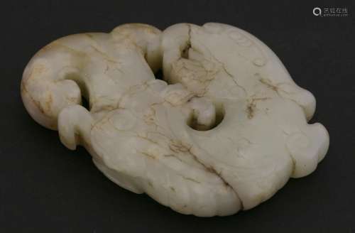 A fine jade carving, probably Ming dynasty (1368-1644), of an archaic mythical creature amongst ...