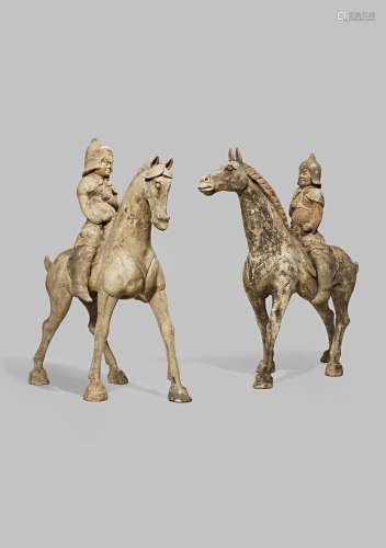 A PAIR OF CHINESE POTTERY MODELS OF HORSES AND RIDERS TANG DYNASTY 618-907 AD Each in a dynamic pose