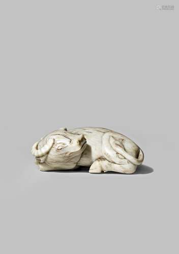 A CHINESE CREAMY-GREY JADE MODEL OF A RECUMBENT BUFFALO PROBABLY 18TH CENTURY With its head turned