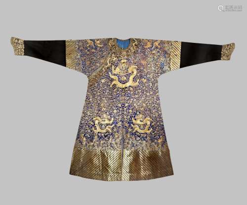 A CHINESE BLUE-GROUND 'NINE DRAGON' ROBE, JIFU LATE QING DYNASTY Embroidered with gold and silver