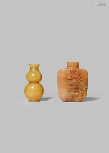 TWO CHINESE HARDSTONE SNUFF BOTTLES 19TH CENTURY One carnelian-agate, carved in high relief with a