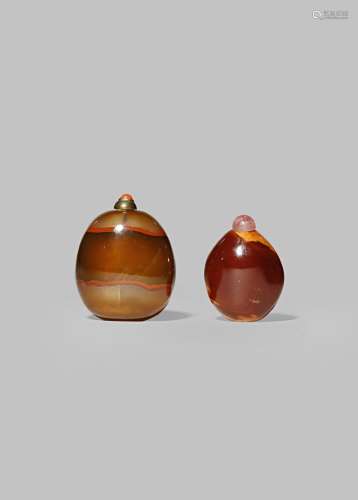 A CHINESE AMBER SNUFF BOTTLE AND AN AGATE SNUFF BOTTLE 19TH CENTURY The former of pebble form, the