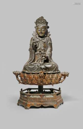 A LARGE CHINESE BRONZE FIGURE OF GUANYIN MING DYNASTY Seated in padmasana, wearing flowing robes, an