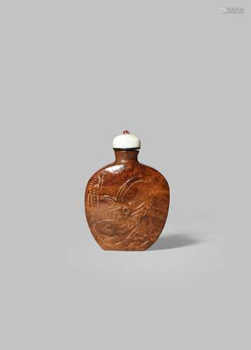 A CHINESE BURR-WOOD SNUFF BOTTLE 19TH CENTURY The flattened body carved with a leafy tree to one