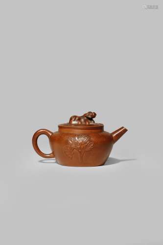 A CHINESE YIXING TEAPOT AND COVER QING DYNASTY With an ovoid body moulded with sprays of
