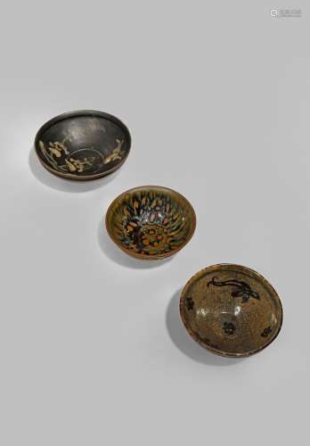 THREE CHINESE GLAZED STONEWARE BOWLS SONG DYNASTY 960-1279 One Jizhou, with a paper-cut design of