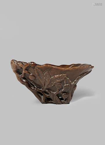 A CHINESE RHINOCEROS HORN 'LOQUAT' LIBATION CUP QING DYNASTY The flared body carved as a large