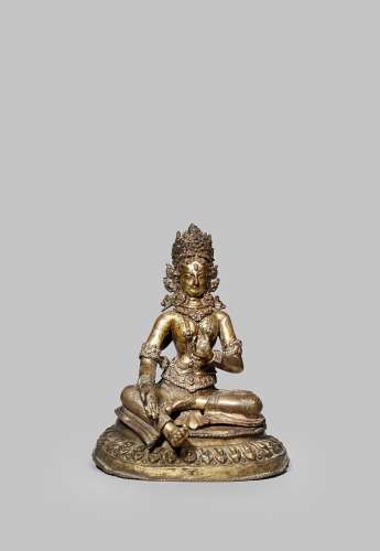 A TIBETO-CHINESE GILT COPPER REPOUSSE FIGURE OF GREEN TARA 17TH/18TH CENTURY Seated, wearing an