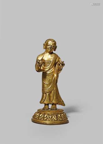 A CHINESE GILT BRONZE FIGURE OF A LUOHAN 18TH CENTURY Standing, wearing flowing robes and holding