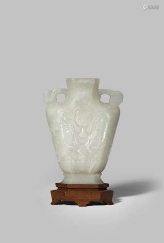 A CHINESE PALE CELADON JADE FLATTENED VASE QING DYNASTY The V-shaped body carved in shallow relief