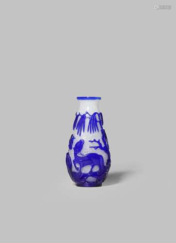 A CHINESE BLUE-OVERLAY GLASS SNUFF BOTTLE 18TH /19TH CENTURY With a pear-shaped body carved