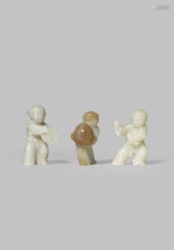 THREE CHINESE PALE CELADON JADE FIGURES OF CHILDREN QING DYNASTY OR LATER One carrying a large