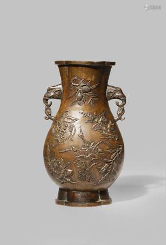 A CHINESE BRONZE PEAR-SHAPED VASE 17TH/18TH CENTURY The body cast with flowers and fruit, with a