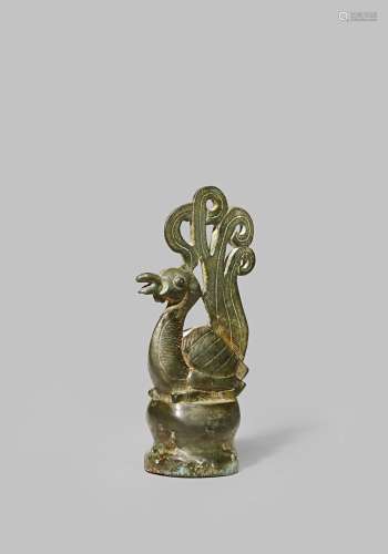 A CHINESE BRONZE 'PHOENIX' FINIAL ORDOS 5TH - 3RD CENTURY BC Cast seated upon a circular base with