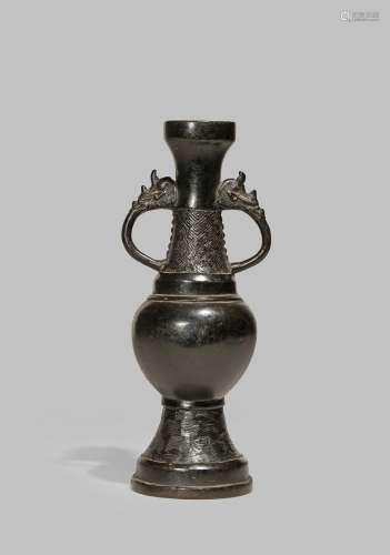 A CHINESE BRONZE VASE YUAN DYNASTY With a plain ovoid body, two dragon head-shaped handles, a