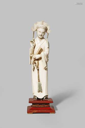 A CHINESE IVORY FIGURE OF A SCHOLAR LATE 18TH CENTURY Standing, wearing long robes tied at the waist
