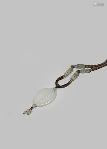 A CHINESE WHITE JADE PENDANT 20TH CENTURY Finely carved with a boy hitting a shuttlecock with a bat,