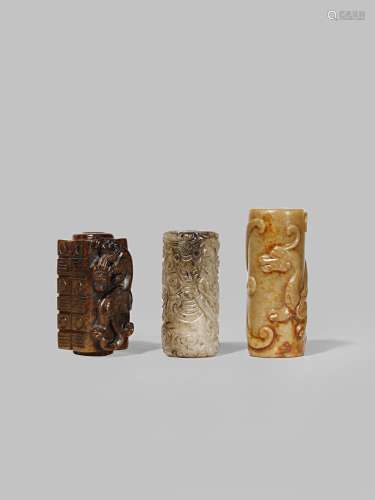 THREE CHINESE JADE CYLINDRICAL BEADS QING DYNASTY OR LATER One of brown stone in the form of a