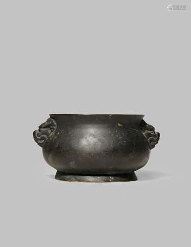 A CHINESE BRONZE INCENSE BURNER QING DYNASTY With a compressed circular body and lion mask handles