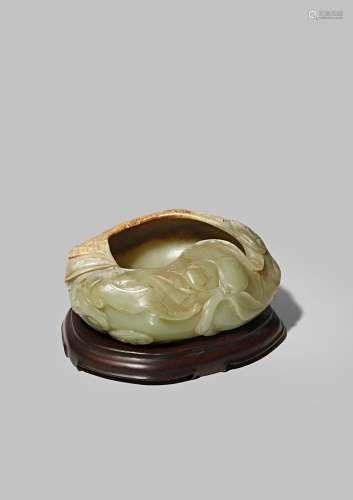 A CHINESE CELADON JADE BRUSH WASHER QING DYNASTY Carved as a large peach with a stem, leaves and