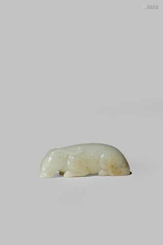 A CHINESE PALE CELADON JADE ARCHAISTIC CARVING OF A MYTHICAL BEAST QING DYNASTY OR LATER