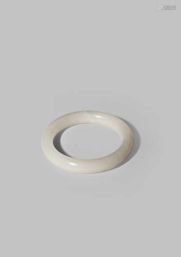 A CHINESE WHITE HARDSTONE BANGLE QING DYNASTY OR LATER The stone of an even white colour, 7.9cm.